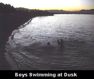 Boys Swimming at Dusk